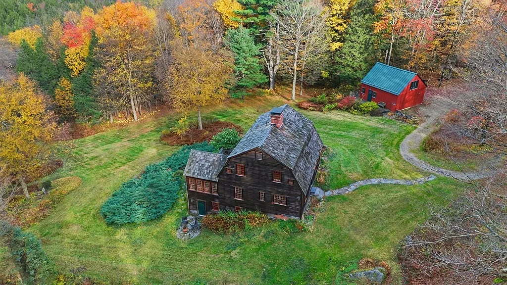 Aerial view of the sanctuary — main house and red barn in peak fall foliage