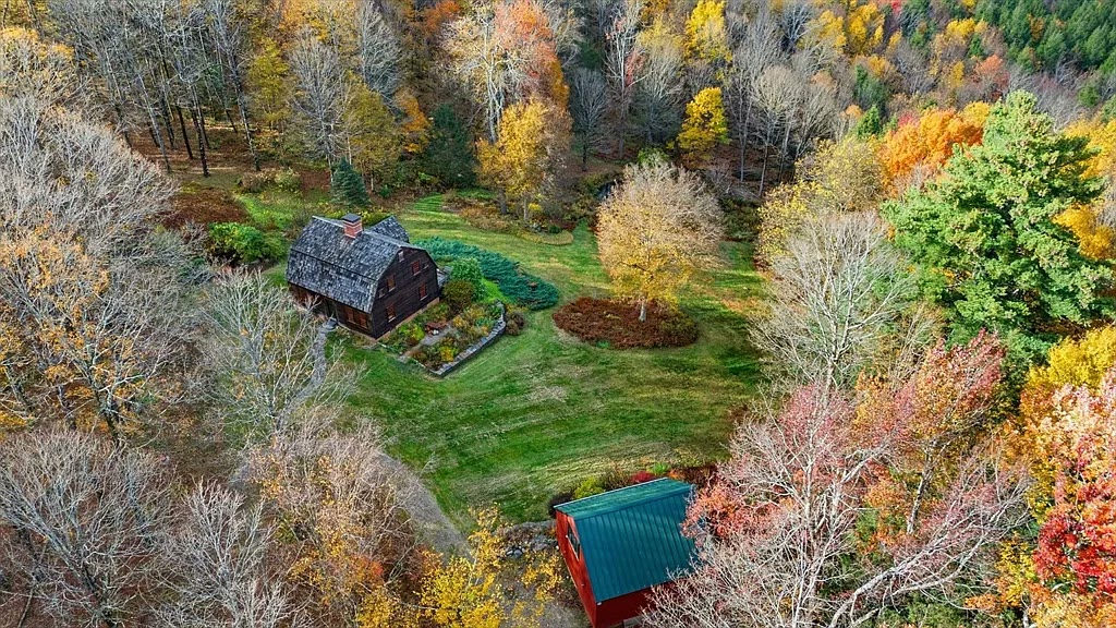 High aerial — the property nestled in 47 acres of fall foliage